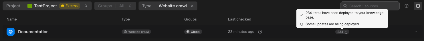 Source row showing the deployed page count with a spinner while some updates are still being deployed